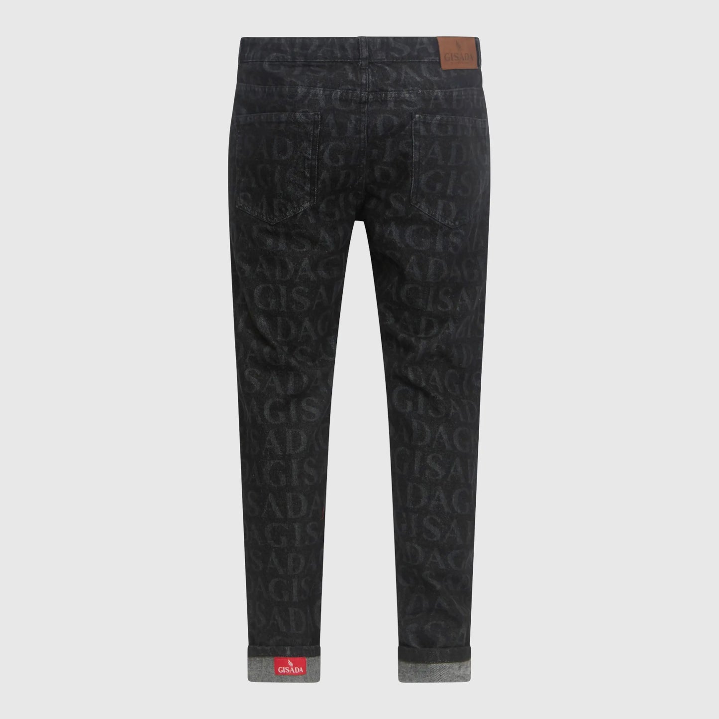 Folded cuff detail showing Gisada red woven inner label on black denim