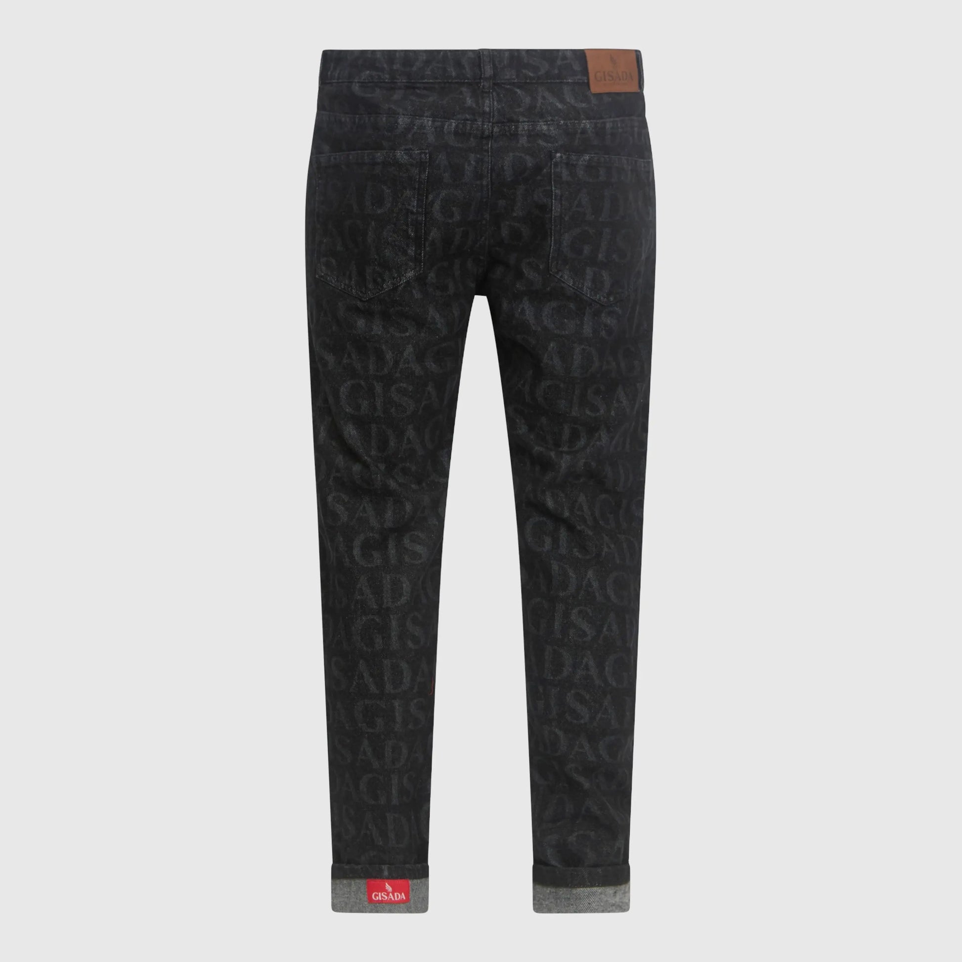 Folded cuff detail showing Gisada red woven inner label on black denim